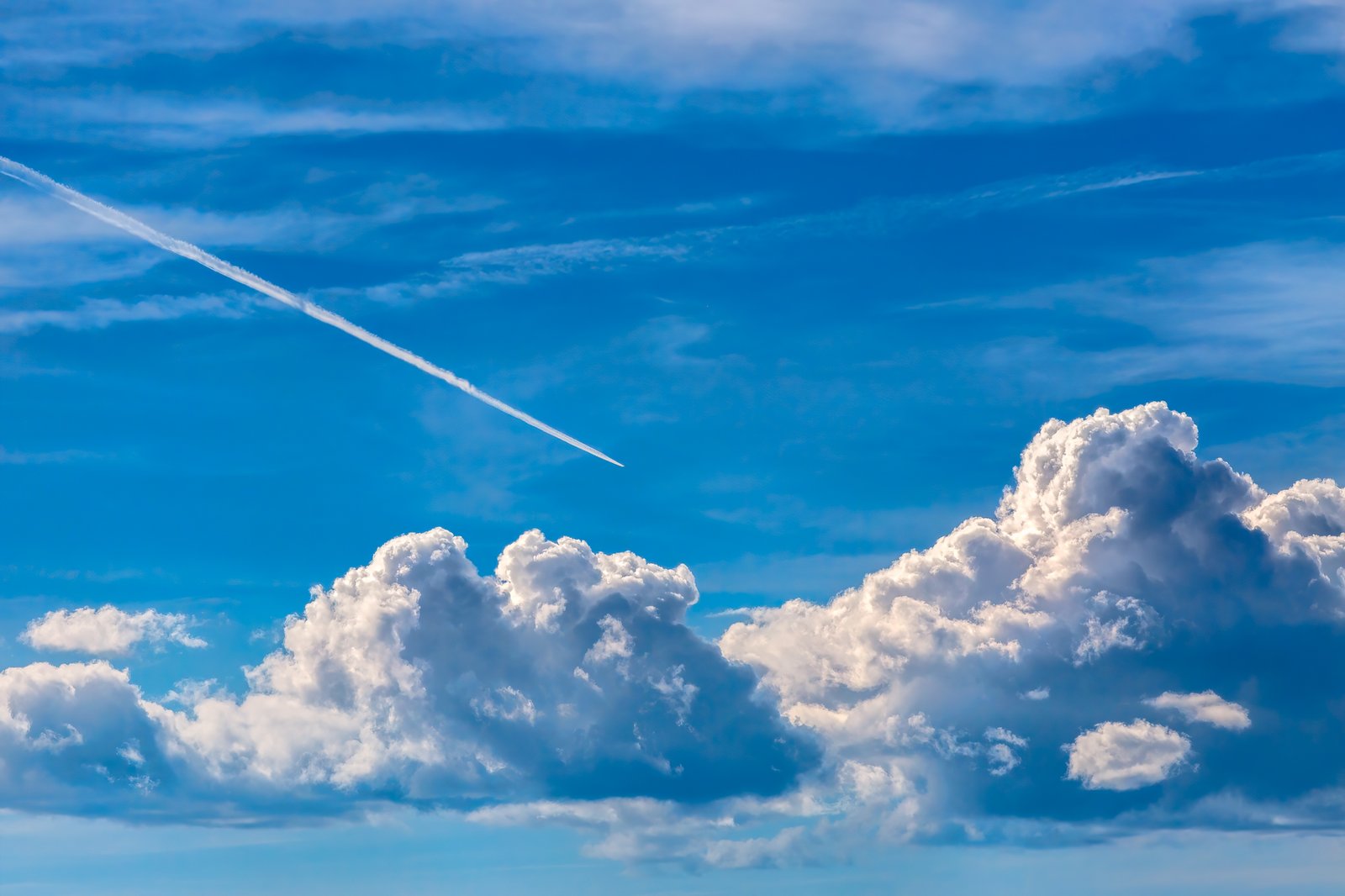 A condensation trail spreading behind an aircraft, its persistence determined by the humidity of the air it was released into