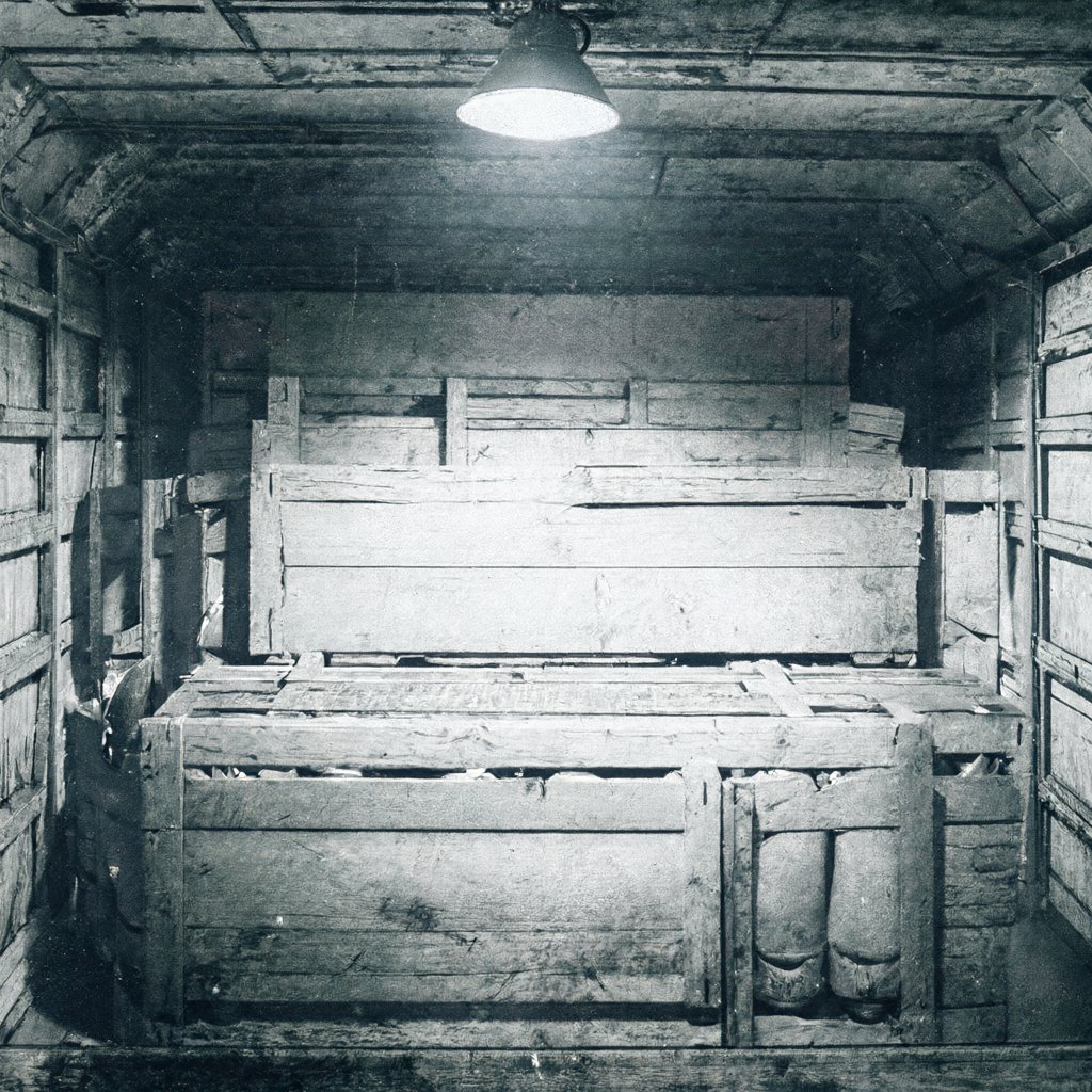 Illustration of wooden crates of missiles in an unmarked cargo hold beside an open document case, deserted, no people