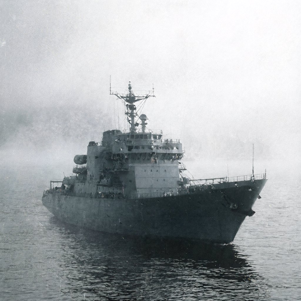 Illustration of a gray naval vessel sitting offshore in heavy fog with a coastal city dim behind it, deserted, empty water